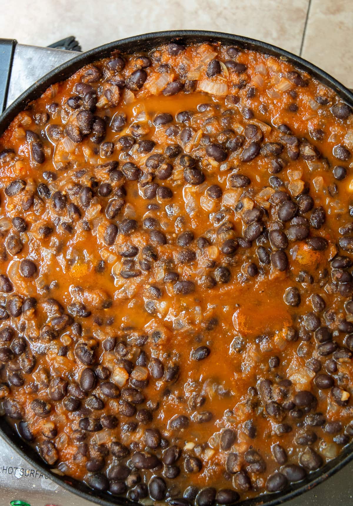Black beans beans added to the enchilada skillet