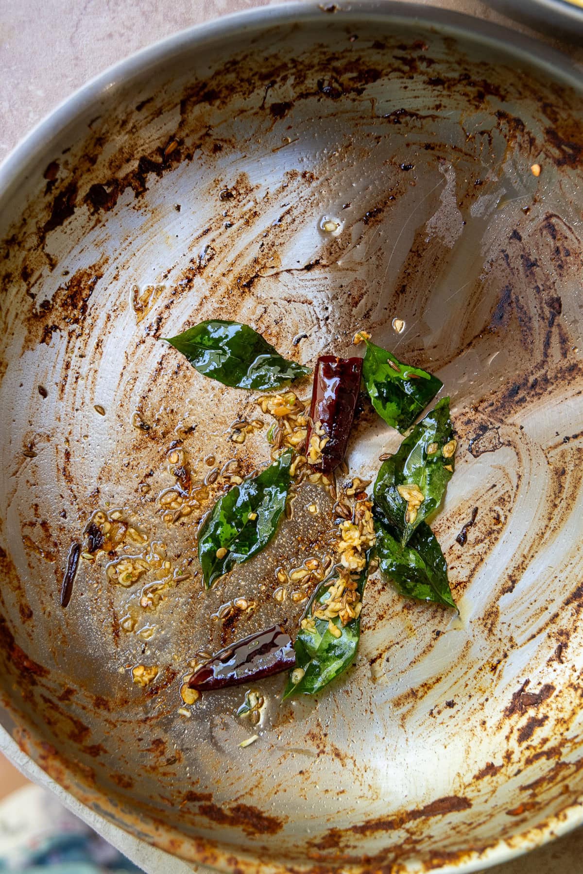 Tadka(tempering) being made in the same pan as the onion-tomato mixture. 